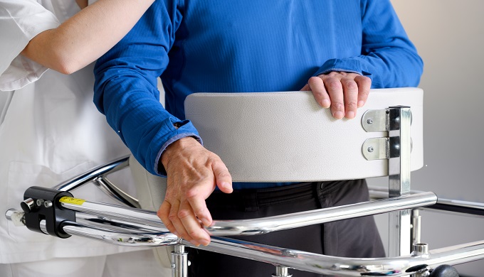 Physiotherapist assisting a patient with Amyotrophic Lateral Sclerosis