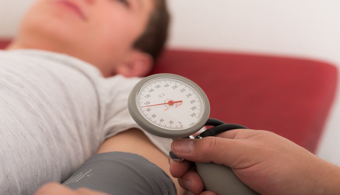 Women lying down to have her blood pressure taken